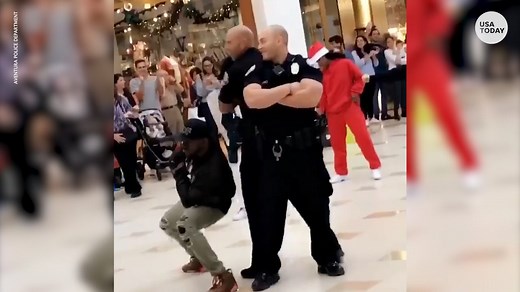 Police bust a move during mall flash mob