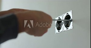 Man hands of electrician dismantling old socket using screwdriver. Replacing electrical outlet. Installing. Repair. Electricity. Stock Video
