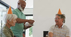 Happy senior diverse people at birthday party with cake at retirement home