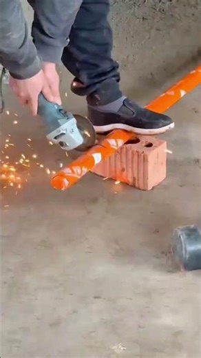 Cutting Plastic Pipe Worker Using an Angle Grinder on a PVC Tube