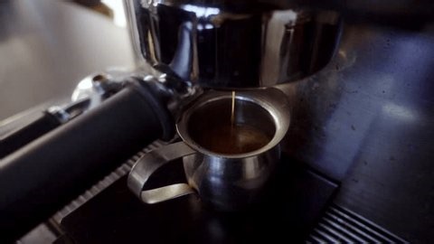 clip-3996269065-close-up-espresso-extraction-coffee-machine-into-small