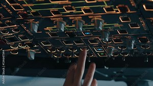 Close shot of overhead panel of modern aircraft with captain's hand switching control buttons and knobs. Interior of Airbus A319 A320 A321