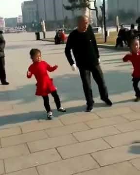 Chinese grandpa and two girls shuffle dance