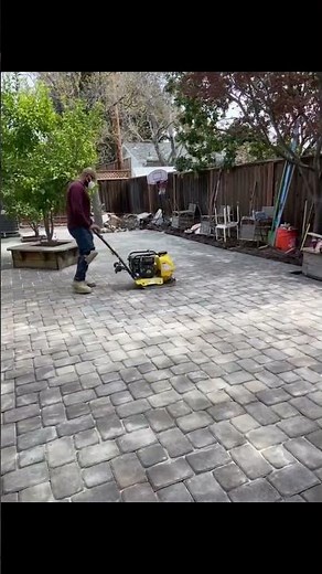 Compacting pavers and applying polymeric sand