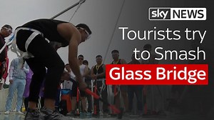 Fancy a walk on the wild side? Tourists in China invited to smash up Zhangjiajie Glass Bridge... while they were stood on it - all in the name of safety | Sky News