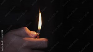 lighter in the dark ignites in slow motion Stock Video