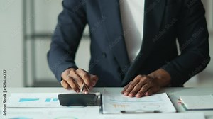 Male accountant calculations and analyzing financial graph data with calculator and laptop Business, Savings Banking Concept.