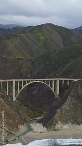 Bixby Creek Bridge. Pacific Coast Highway and Ocean. Big Sur, California, USA. Aerial View. Drone Flies Forward. Vertical Video