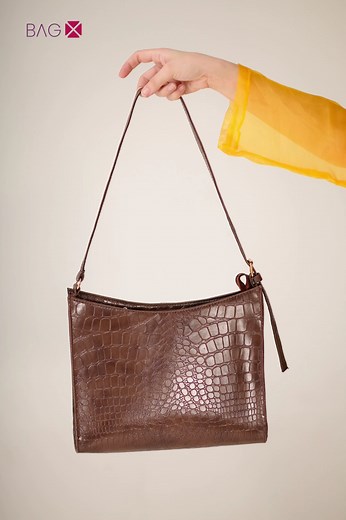 8.5K views · 19 reactions | Check out our stunning Half Moon Crocodile Bag in action!  Crafted with premium crocodile-textured leather, this bag is both luxurious and versatile. Its unique half-moon shape adds a touch of chic to any outfit. Elevate your style with this must-have accessory today ! www.bagx.pk #FashionForward #HalfMoonBag #CrocodileLuxury #ChicStyle #FashionForward | Bag-X | Facebook