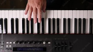 Overhead of Male Hand Practicing A Piano Scale on an Electronic Keyboard.
