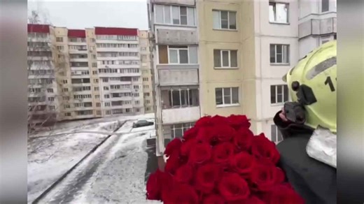 Fireman uses truck's crane to propose to girlfriend through her fourth floor window