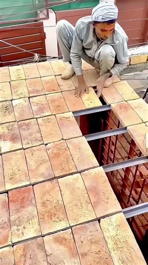Traditional Brick Roofing Skilled Craftsmen Installing Clay Bricks on a Metal Frame Grid