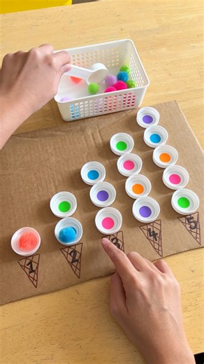 17K views · 75 reactions | Scoop, match and count! A simple, hands-on counting activity using bottle caps and pom poms—perfect for strengthening number sense and fine motor skills. Follow @happytotshelf for more fun learning ideas! #EarlyMathSkills #HandsOnLearning #ToddlerActivities #PreschoolActivities | Happy Tot Shelf - Raising Happy Learners | Facebook
