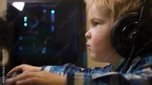 Little Child Plays Watches Listens to Music on Computer. Father's Editing PC Workstation. Gaming PC