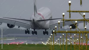 Big aircraft landing on a runway with visible lighting and infrastructure - real time version Stock Video