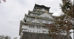 Low angle shot looking up at Osaka Castle in Osaka, Japan. Slow pan right.