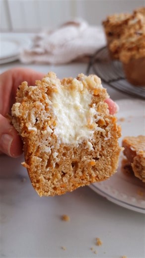 Katarina Cermelj on Instagram: "Gluten-free carrot cake muffins 🥕🧡 Because every season is carrot cake season – and this muffin version is INCREDIBLE. They're soft and moist, stuffed with a creamy vanilla cheesecake filling and topped with a crisp, buttery streusel. And they're sooo easy to make, it's really a no-fuss, fail-proof recipe. Coarsely (not finely!!) grated carrots and a fairly thick batter are essential here, they'll ensure that the muffins have the perfect texture and nicely domed