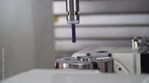 Demonstration of work of CNC milling machine drilling metal part, example of drilling boring chamfer of workpiece in workshop for metalworking industry