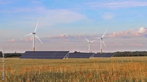 A renewable energy power video with three solar panels and three wind electric generators on a summer field