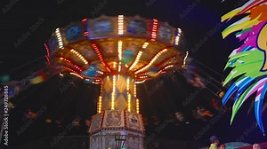 Malang, East Java, Indonesia - February 13, 2019: Wave swinger ride at night in Batu Night Spectacular Amusement Park. Shot in 4k resolution