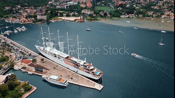 Old town Kotor Montenegro on the coast of Boka bay in the Mediterranean. Vacation destination and tourist trap in Europe. Aerial drone view of waterfront and stone houses.