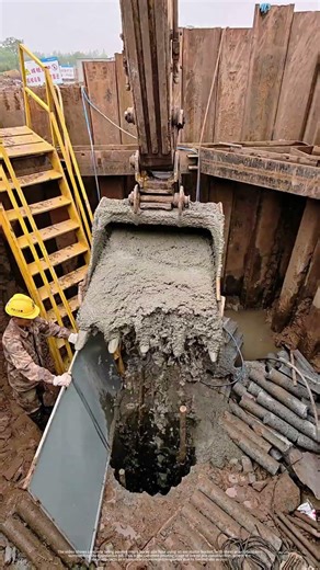 Pouring Concrete Into A Bored Pile Using An Excavator Bucket