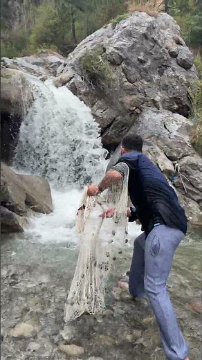 Casting net in the base of waterfall #fishing