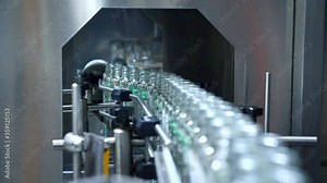 Juice bottling plant. Glass bottles on conveyor belt in beverage factory. Robotic automation line.