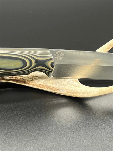 This is Elsa's Camp Profile. Made with CPM Magna-Cut 63HRC, handle is Camo ultrex suretouch with carbon fiber pins and lanyard tube. Comes with olive drab kydex, lifetime warranty and resharpening for life. The suretouch is alternating G10 and rubber so it is grippy when wet. Blade is 6 inches, OAL is 10.5 inches. #fyp #foryoupage #montana #madeinmontana #custom #elsasedge #hunter #camp