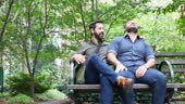 Mature adult gay men relaxing outdoors in a New York park