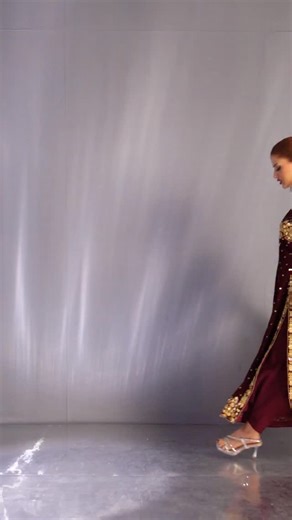 Maroon majesty ♥️ “REGALIA EDIT — where heritage meets high glamour. Draped in deep maroon velvet and adorned with intricate gold handwork, this masterpiece celebrates timeless royalty. The rich craftsmanship, ornate detailing, and regal silhouette come together to create a look that speaks of tradition, power, and pure elegance. Paired with a luminous gold dupatta, this ensemble is designed for the woman who carries grace like a crown and steps into every moment with undeniable presence. A stat