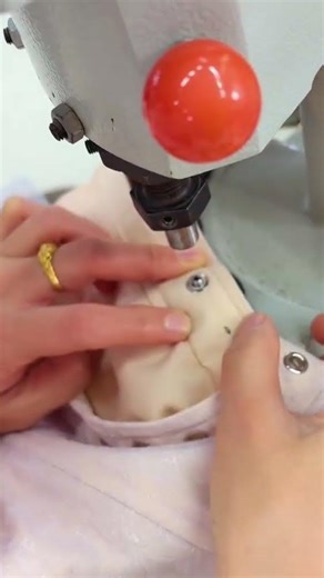 the process of attaching press studs to fabric using a press machine