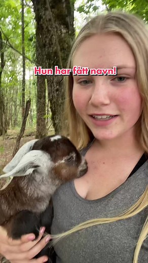 Young Woman's Heartwarming Goat Interaction in Nature