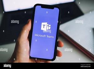 Hand holding iPhone with Microsoft Teams video call app logo on the screen Stock Photo - Alamy