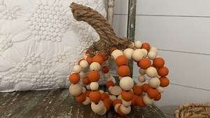 This pumpkin is made from wood beads!! Yes! And it is absolutely adorable, check out how easy it is to make. | The Celebration Co.