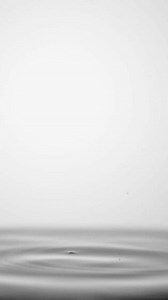 4X slow motion video Water droplets falling on water surface Water splashing