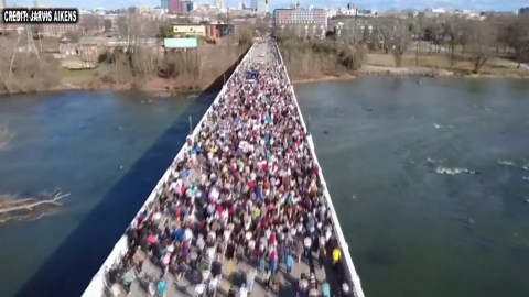 Buddhist monks cross Gervais Street Bridge on walk for peace