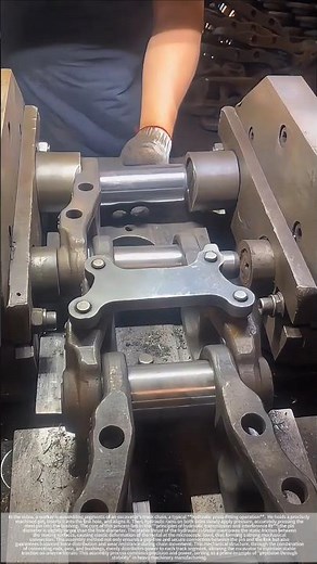 The power of hydraulics allows the steel tracks to interlock, forming a cohesive chain of force.