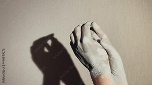 romantic movements of hands, a couple in love. smooth movements of male and female hands close-up, in a pottery workshop, all in clay.
