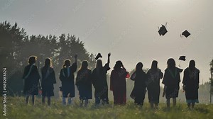 Graduates are celebrating throwing their graduation caps in the air
