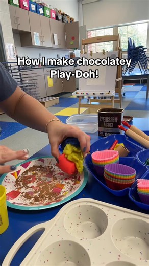 Here’s how I make chocolatey Play-Doh for our Play-Doh center 🍫✨ I mix the primary colors—one can of red, one can of blue, and one can of yellow—and it blends into brown. Then I add cocoa powder to make it smell just like chocolate batter. To go along with it, I set out all the fun cupcake materials: silicone cupcake liners, gems for sprinkles, candles (both regular and number candles), rolling pins, and a cupcake pan. The kids love pretending to bake their own Play-Doh cupcakes! 🧁 | Preschool