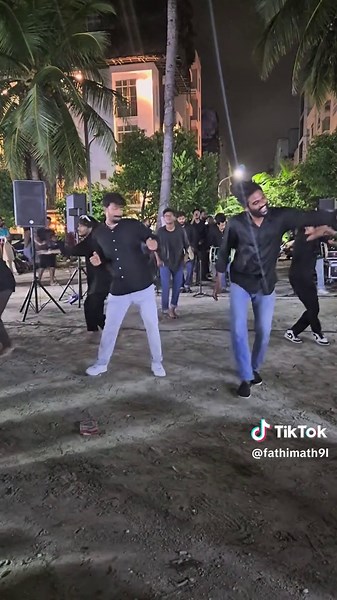 Synchronized Night Dance Performance in Tropical Setting