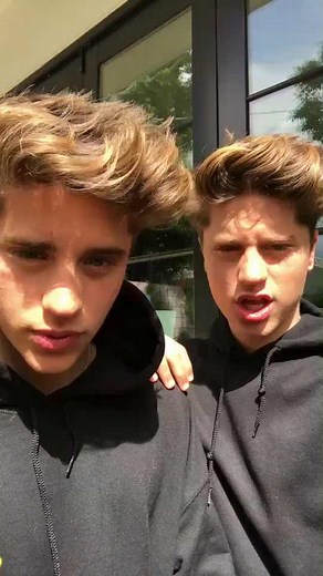 Twins Bonding Outdoors in Stylish Black Hoodies