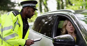 4K Friendly police officer having a conversation with female driver in her car. Slow motion. Stock Video