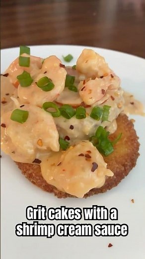 Grit cakes topped with shrimp and cream sauce