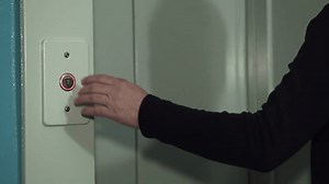 clip-1111237671-hand-man-pressing-elevator-button-person-enters