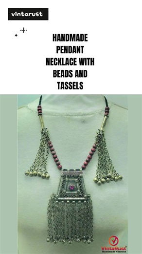 Handmade Pendant Necklace with Beads and Tassels This antique red-hued beaded tribal pendant necklace offers an ethnic feel with its rustic hues and matte, antique oxidized finish. Made with antique brass, this elegant necklace is truly one-of-a-kind. In Afghani tradition, precious stones are believed to benefit human health, with many tribes attributing magical powers to jewels. The main cord of this vintage pendant necklace is adorned with beautiful beads and antique hanging metal charms. The 