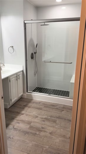 Meier Construction, LLC on Instagram: "Kicking off the new year with a finished masterpiece ✨🚿 Brand new large-format tile shower, black hexagon glass swirl/gold accents, custom niche + bench, fresh vinyl floors, paint, cabinet & countertop refinishing, new lighting, custom mirror, and a new toilet to top it off. This is part 1 of a 2-bath project (master bath + hallway bath), and we’re already loving how it turned out. If your bathroom is feeling tired or outdated, let us help you build your d