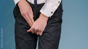 Man holding his groin with his hands feeling discomfort and pain. Concept: prostatitis, urethritis and other diseases of the urinary-reproductive system