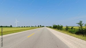 Cinematic POV shot of asphalt road at country side in Canada. Point of view, front car view. Road ahead driving view. Front view on car hood during travel driving on the highway. Vehicle speeding view